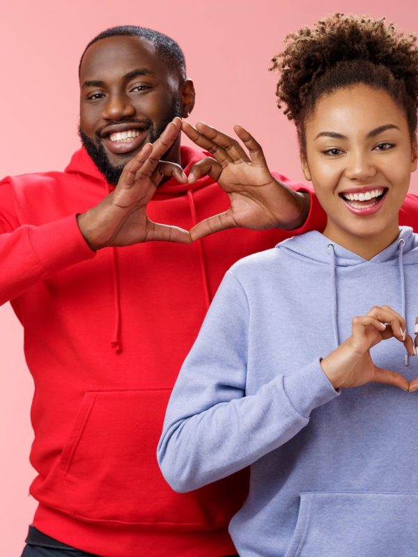 Charming joyful caring young african american family man woman siblings smiling broadly show heart gestures grinning express love empathy positivity, two loyal friends cherish friendship.