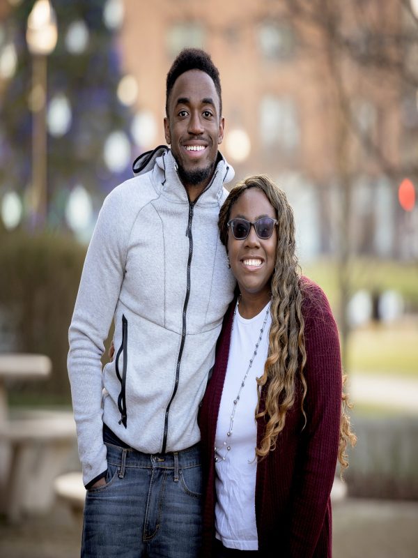 A cute selective focus shot of two friends smiling and posing together