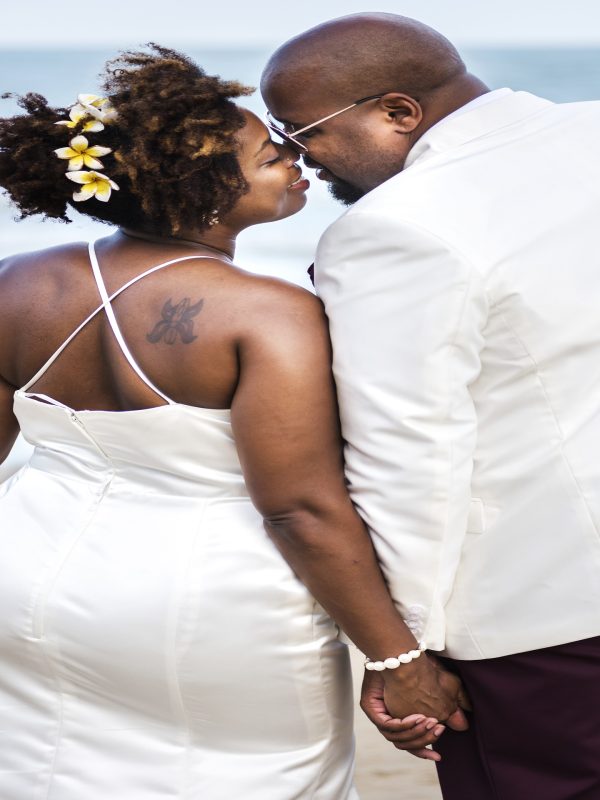 African American couple getting married at the beach